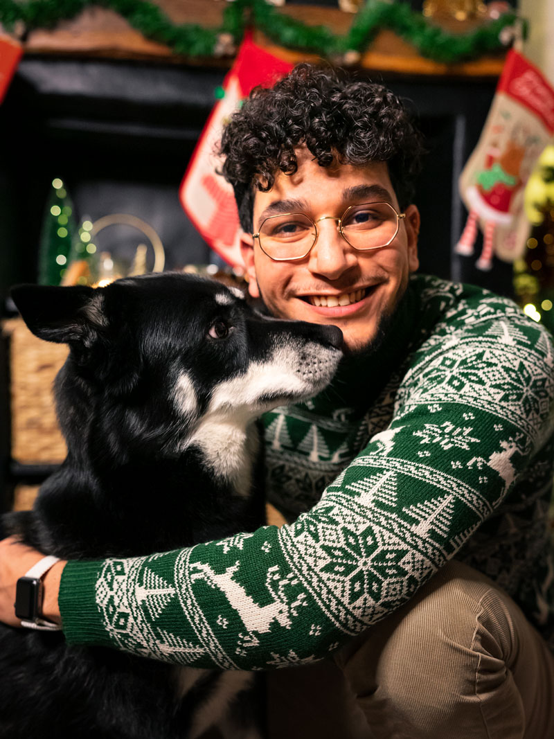 photo d'un homme pendant les fêtes de Noël avec son chien, animal de compagnie carousel desktop